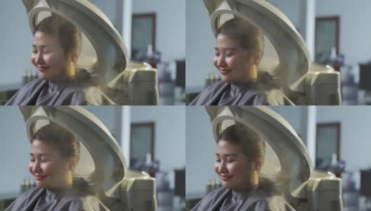 亚洲华人女性在美发厅进行头发蒸润治疗高清在线视频素材下载