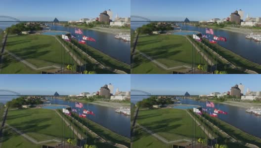 在泥岛河公园七根旗杆上挥舞旗帜，孟菲斯，田纳西州。赫尔南多·德索托大桥和密西西比河的背景高清在线视频素材下载