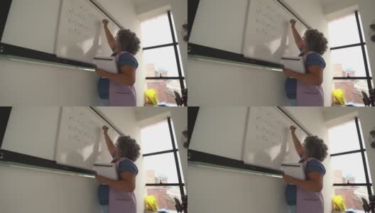 老师在黑板上写字，戴着口罩高清在线视频素材下载