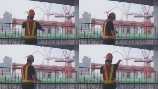 建筑工人亚洲人用智能手机操作。控制工人建造一座大楼。6、安全帽，防止事故发生。电话会议在工作高清在线视频素材下载