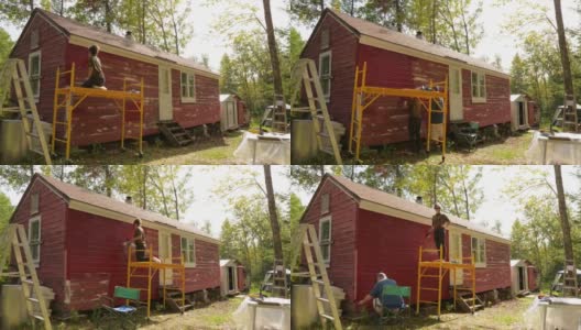 时间的推移，人们在一个农场粉刷一个小木屋红色高清在线视频素材下载