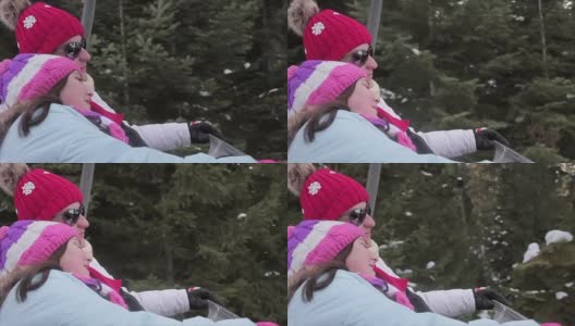 母亲和女儿骑滑雪缆车在寒假，近距离高清在线视频素材下载