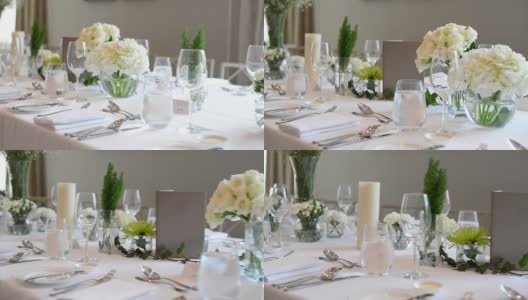 豪华婚礼的餐桌布置，桌上摆放着美丽的鲜花高清在线视频素材下载