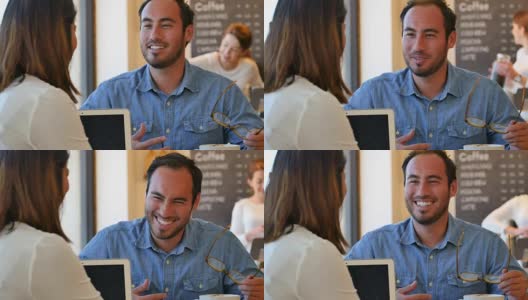 一个年轻的西班牙人在工作前和朋友在咖啡馆里聊天高清在线视频素材下载
