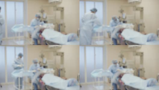 医生在病人身上进行手术，画面在离焦处高清在线视频素材下载