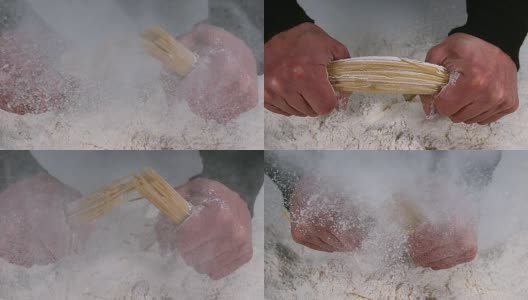 男人的手在面粉背景下打破意大利面，慢镜头4K高清在线视频素材下载