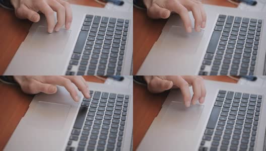 一个研究生使用一个科学数据库来编辑研究工作，使用笔记本触控板，在触控板上驱动一个手指高清在线视频素材下载