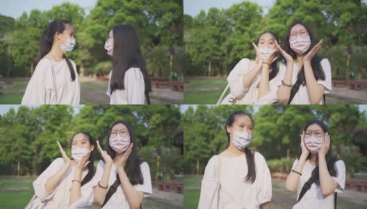 亚洲少女姐妹戴着口罩微笑应对新冠肺炎疫情高清在线视频素材下载