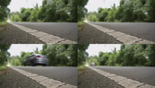 低水平角度摄像机拍摄的汽车在道路上行驶的场景高清在线视频素材下载