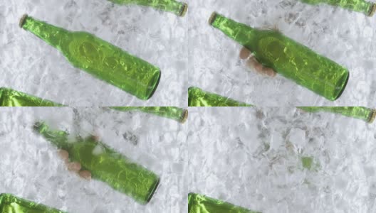 一个男人的手从冷藏箱里拿出啤酒瓶的特写高清在线视频素材下载