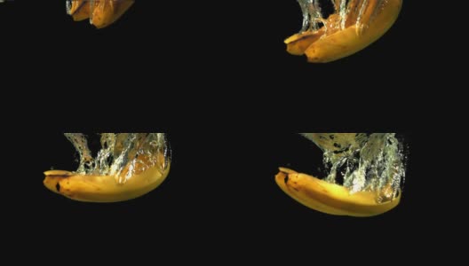 黑色背景下的超级慢动作，香蕉带着气泡落入水中。拍摄速度为1000帧/秒。高清在线视频素材下载