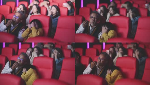 亚洲华人活跃的老人和他的孙女在电影院看恐怖惊悚电影高清在线视频素材下载