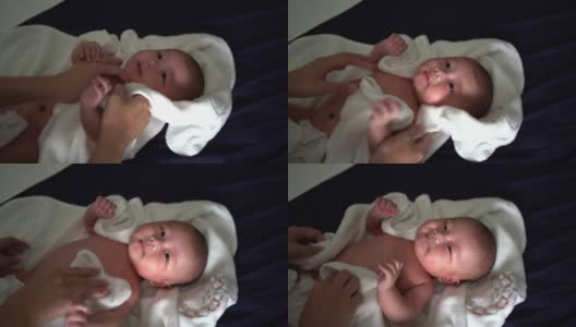 婴儿洗澡后，母亲用毛巾擦干身子高清在线视频素材下载