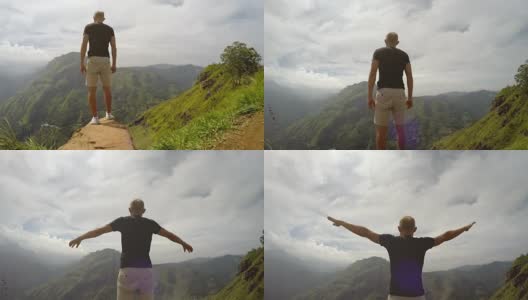 一名男子伸出双手爬山的4K视频高清在线视频素材下载