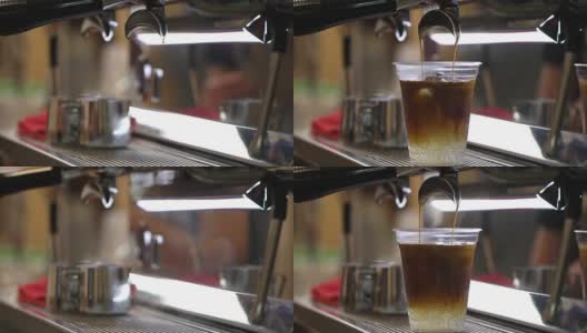 特写新鲜冰咖啡，冷咖啡与冰块在一次性透明杯简单地倒在冰。意大利浓缩咖啡机。咖啡文化和专业的咖啡制作、咖啡送走、服务、餐饮理念高清在线视频素材下载
