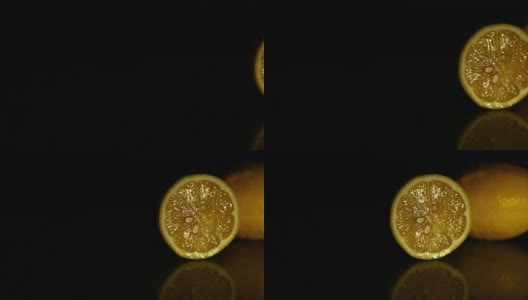 两个多汁的柠檬躺在黑暗中。高清高清在线视频素材下载