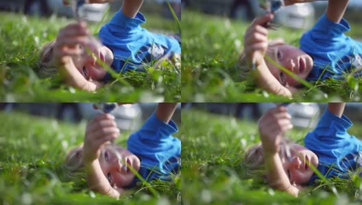 孩子躺在外面的草地上做着白日梦玩耍高清在线视频素材下载
