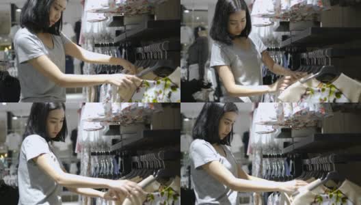 女人在购物中心内的时装店购物高清在线视频素材下载