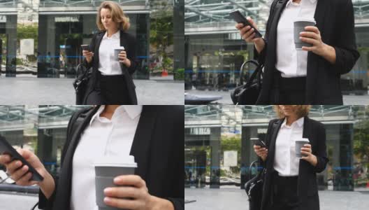 女商人在办公大楼里用咖啡杯玩智能手机高清在线视频素材下载
