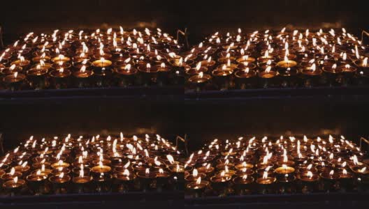 在尼泊尔加德满都的一座寺庙中点燃仪式蜡烛高清在线视频素材下载