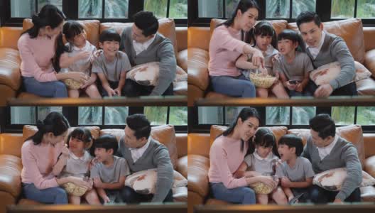 周年快乐的亚洲家庭一起坐在家里的客厅里。父亲和母亲放松与儿子和女儿。白人家庭观念，教育，小学。高清在线视频素材下载