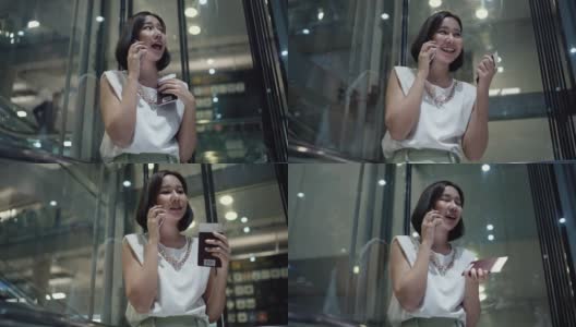 美女拿着智能手机和护照在透明电梯里高清在线视频素材下载