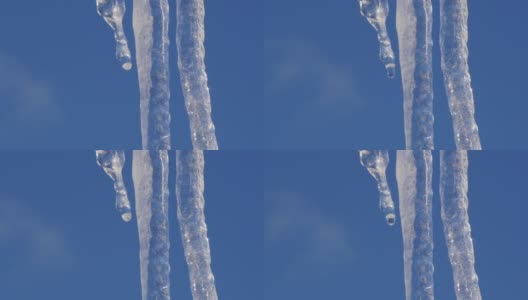 水滴从大冰柱上掉下来。阳光明媚的春天高清在线视频素材下载