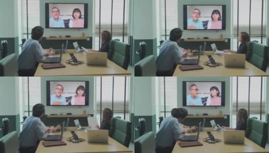 亚洲白领与公司员工进行视频会议会议讨论在会议室董事会与外国投资者进行视频会议。公司并购业务会议高清在线视频素材下载