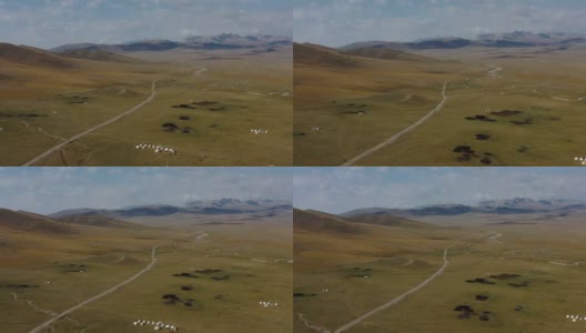俯瞰风景优美的荒野蒙古包营地和吉尔吉斯斯坦松吉湖的公路高清在线视频素材下载