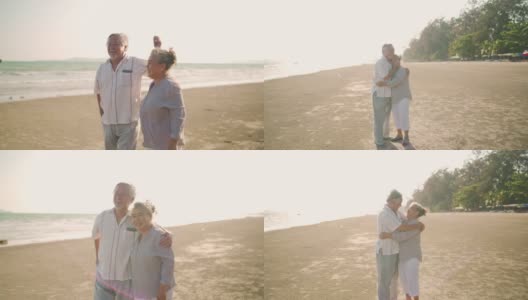 4K亚洲老年夫妇在夏日日落的海滩上享受浪漫的假期，翩翩起舞高清在线视频素材下载