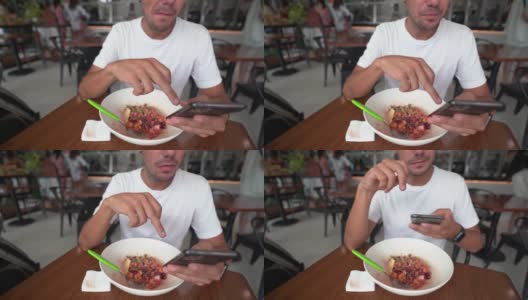 年轻的西班牙男子一边吃沙拉一边用手机拍下了这张照片高清在线视频素材下载