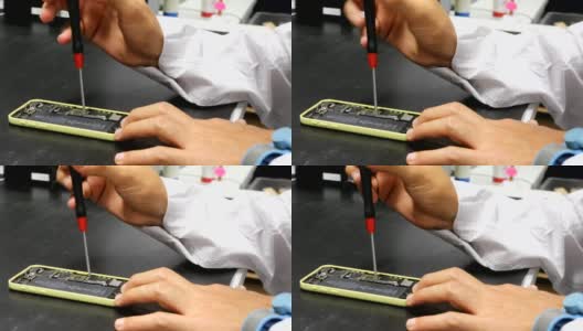 工程师用螺丝刀修理智能手机高清在线视频素材下载