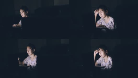 亚洲女性在就寝时间坐在客厅里使用笔记本电脑高清在线视频素材下载